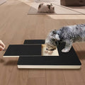 Dog filing its nails on the PawFile scratch board while taking treats from the built-in treat box
